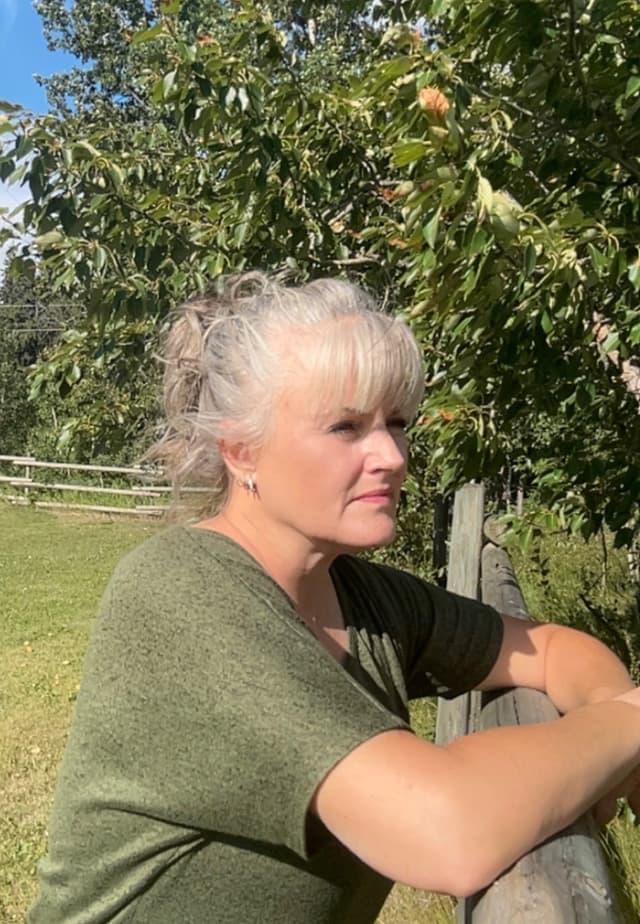 Renee looking out over a fence